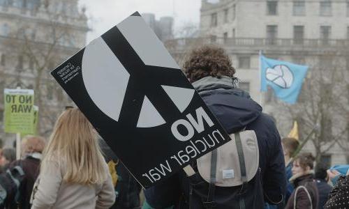  一名男子在伦敦特拉法加广场的集会上举着牌子, ‘No Nuclear War’, 争取核裁军, 支持处于战争中的乌克兰人民.